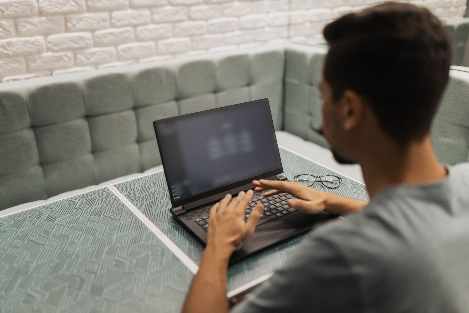Close-up of hands working on a laptop